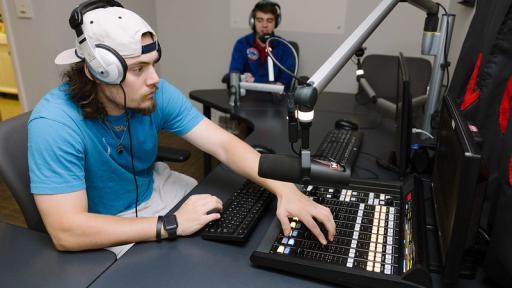 Student behind the scenes at the WONC radio station